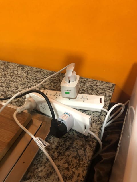 Travel adapters in a wall socket