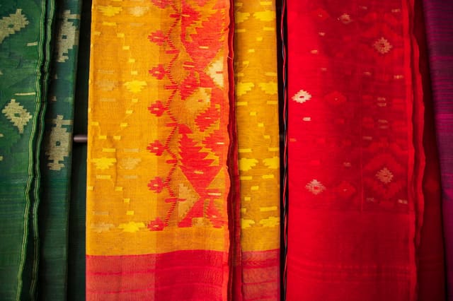 Bangladeshi  Traditional Colorful Jamdani saree hanging in the retail Showrooms