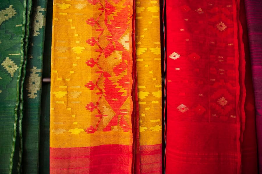 Bangladeshi Traditional Colorful Jamdani saree hanging in the retail Showrooms